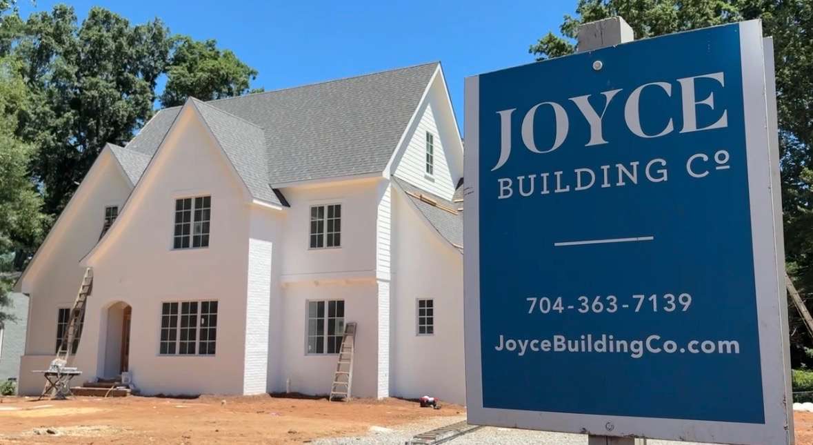 Joyce Building Company jobsite sign in front of a house under construction